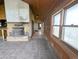 Bright living room with a stone fireplace and tile flooring leads to view of the outdoor scenic views at 11897 Roxburg St, Strasburg, CO 80136