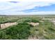 Overhead view of the spacious yard, featuring garden beds and fencing at 11897 Roxburg St, Strasburg, CO 80136