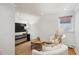 Finished basement area with plush seating, a modern table, hardwood floors, and recessed lighting at 424 S Pennsylvania St, Denver, CO 80209