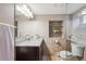 Well-lit bathroom with granite countertop, shower, and mosaic tile accents at 424 S Pennsylvania St, Denver, CO 80209