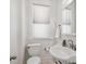 Half bath with white fixtures, natural light and neutral color scheme at 424 S Pennsylvania St, Denver, CO 80209