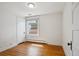 Cozy bedroom with hardwood floors, white trim, radiator, and natural light from a large window at 424 S Pennsylvania St, Denver, CO 80209