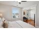 Bright bedroom features hardwood floors, a ceiling fan and detailed windows at 424 S Pennsylvania St, Denver, CO 80209