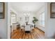 Elegant dining room features modern chandelier, white chairs, and natural light at 424 S Pennsylvania St, Denver, CO 80209