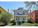 Charming two-story home with inviting front porch and well-manicured lawn, perfect for Gathering living at 424 S Pennsylvania St, Denver, CO 80209