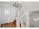 Bright foyer with hardwood floors and white staircase, offering a stylish and welcoming entrance to the home at 424 S Pennsylvania St, Denver, CO 80209