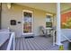 Inviting front porch features cozy seating, decorative door, and architectural details, creating a welcoming entrance at 424 S Pennsylvania St, Denver, CO 80209