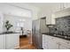 Modern kitchen with stainless steel appliances, white cabinetry, and an open layout at 424 S Pennsylvania St, Denver, CO 80209