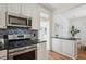Well-equipped kitchen features stainless steel appliances, tile backsplash, and hardwood floors at 424 S Pennsylvania St, Denver, CO 80209
