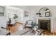 Open-concept living room with hardwood floors, fireplace, and seamless flow to dining area, perfect for entertaining at 424 S Pennsylvania St, Denver, CO 80209