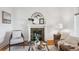 Elegant living room with decorative fireplace, plush furnishings, and abundant natural light, exuding warmth at 424 S Pennsylvania St, Denver, CO 80209