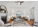 Bright living room with fireplace, plush seating, and decorative stained glass window at 424 S Pennsylvania St, Denver, CO 80209