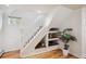 Staircase with custom built-in shelving, natural light, and new hardwood floors at 424 S Pennsylvania St, Denver, CO 80209