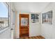 Cozy sunroom with multiple windows and a wooden door at 424 S Pennsylvania St, Denver, CO 80209
