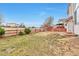 Fenced-in backyard featuring a lawn, wooden fence, and mature trees, perfect for outdoor activities at 20308 E 46Th Ave, Denver, CO 80249