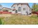Backyard featuring a lawn, patio, wood fence, and mature trees, offering a private outdoor retreat at 20308 E 46Th Ave, Denver, CO 80249