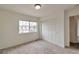 Bedroom featuring carpet, a window providing natural light, and a sliding-door closet for storage at 20308 E 46Th Ave, Denver, CO 80249