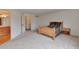 Spacious bedroom with neutral carpet and an attached bathroom entrance at 20308 E 46Th Ave, Denver, CO 80249