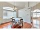 Bright dining room with hardwood floors, large windows, and a chandelier at 20308 E 46Th Ave, Denver, CO 80249