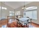 Bright dining room with hardwood floors, large windows, and a chandelier at 20308 E 46Th Ave, Denver, CO 80249