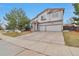 Two-story home featuring a two-car garage and well-maintained front lawn at 20308 E 46Th Ave, Denver, CO 80249