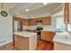 Well-lit kitchen with an island, stainless steel refrigerator and ample counter space at 20308 E 46Th Ave, Denver, CO 80249