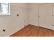 Clean laundry room with wood flooring and available shelving at 20308 E 46Th Ave, Denver, CO 80249
