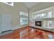 Sun-filled living room with hardwood floors and a cozy fireplace feature at 20308 E 46Th Ave, Denver, CO 80249