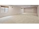 Spacious basement with carpet, two windows for natural light, and ample room for activities at 20500 E Hamilton Ave, Aurora, CO 80013