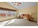 Primary bedroom with neutral walls, a ceiling fan and large windows that let in natural light at 20500 E Hamilton Ave, Aurora, CO 80013