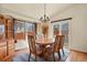 Dining area featuring a chandelier, hardwood floors and a sliding door leading to the backyard at 20500 E Hamilton Ave, Aurora, CO 80013