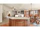 Open kitchen island with granite counters, breakfast bar and an easy flow into the dining area at 20500 E Hamilton Ave, Aurora, CO 80013
