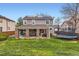 Beautiful backyard with a covered patio and a lush green lawn at 9879 Sydney Ln, Highlands Ranch, CO 80130