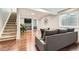 Finished basement with a stylish seating area and hardwood floors at 9879 Sydney Ln, Highlands Ranch, CO 80130