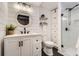 Modern bathroom with a glass shower, white vanity, and shiplap accent wall at 9879 Sydney Ln, Highlands Ranch, CO 80130