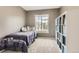 Bedroom with a twin bed, cozy decor, and bright window at 9879 Sydney Ln, Highlands Ranch, CO 80130