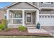Inviting front porch with white railings, a bench, a decorative pot, and a welcoming entryway to this charming home at 9879 Sydney Ln, Highlands Ranch, CO 80130