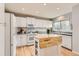 Bright kitchen with white cabinets, modern appliances, granite countertops, and a butcher block island at 9879 Sydney Ln, Highlands Ranch, CO 80130