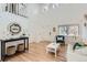 Spacious living room with hardwood floors, a white staircase, and a large window that floods the room with natural light at 9879 Sydney Ln, Highlands Ranch, CO 80130