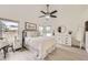 Bright bedroom with a ceiling fan, plentiful natural light, and modern decor at 9879 Sydney Ln, Highlands Ranch, CO 80130