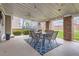 Covered outdoor patio with a dining table set and string lights at 9879 Sydney Ln, Highlands Ranch, CO 80130