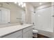 Bright bathroom features a white vanity with a sink and a shower-tub combo with white tile surround at 457 Interlocken Blvd # 105, Broomfield, CO 80021