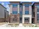Modern townhouse with brick and siding exterior, showcasing the front entrance and landscaping at 457 Interlocken Blvd # 105, Broomfield, CO 80021