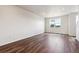 Bright, open living room with hardwood floors and a modern chandelier at 457 Interlocken Blvd # 105, Broomfield, CO 80021