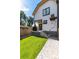 Landscaped backyard with a brick pathway and grassy lawn at 2478 S Lafayette St, Denver, CO 80210