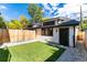 Landscaped backyard with a grassy lawn and shed at 2478 S Lafayette St, Denver, CO 80210