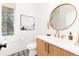 Stylish bathroom with wood vanity, large mirror, and patterned tile floor at 2478 S Lafayette St, Denver, CO 80210