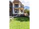 Two-story modern home with dark brick and white siding, showcasing a grassy yard at 2478 S Lafayette St, Denver, CO 80210