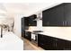 Modern kitchen with black cabinets and a center island at 2478 S Lafayette St, Denver, CO 80210