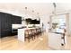 Modern kitchen with black cabinets and a large island at 2478 S Lafayette St, Denver, CO 80210